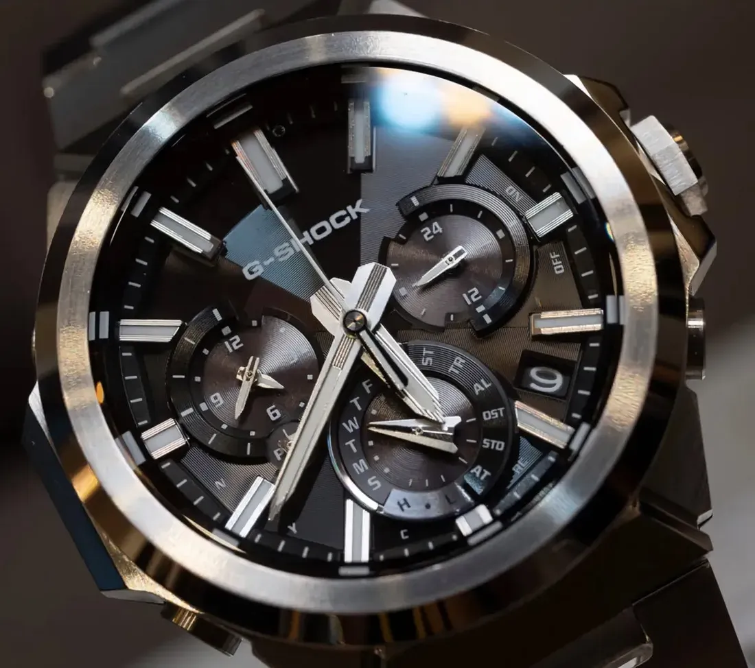 Close-up of the black-dial Casio G-Shock GST-W1000D-1A, showing its three subdials, luminous hour markers, faceted hands, and multi-finish stainless s - Casio's Sleeker G-Steel GST-W1000 Swaps Rugged Bulk for Refined Steel