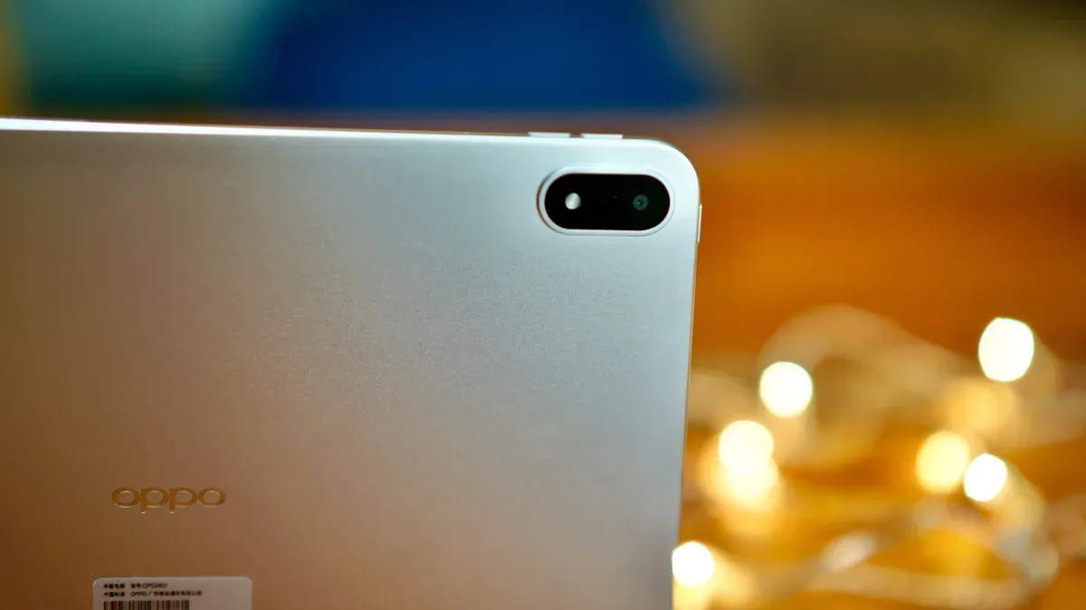 Oppo Pad 6 tablet displaying its metal chassis and thin front screen bezels on a wooden surface