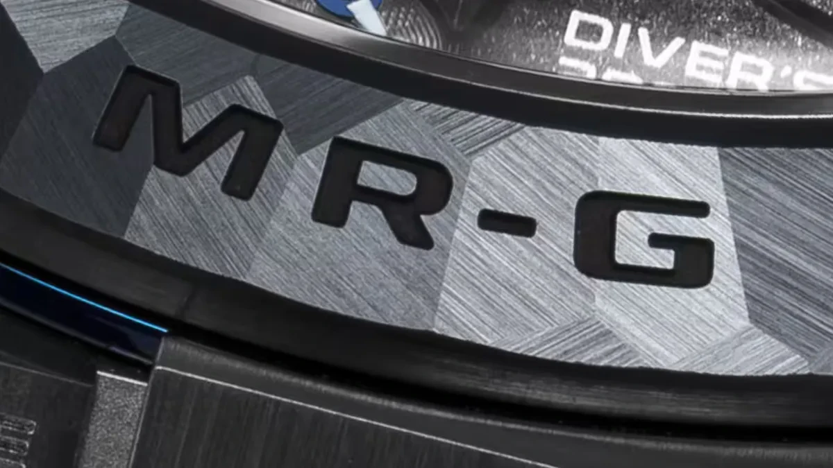 A close-up view of a high-end Casio MR-G watch reflecting light, showcasing the premium metal finishing and intricate dial design.