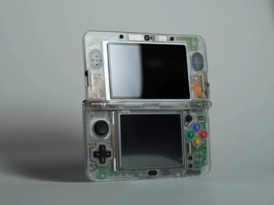 Transparent clear shell kit installed on a Nintendo 3DS XL showcasing internal components