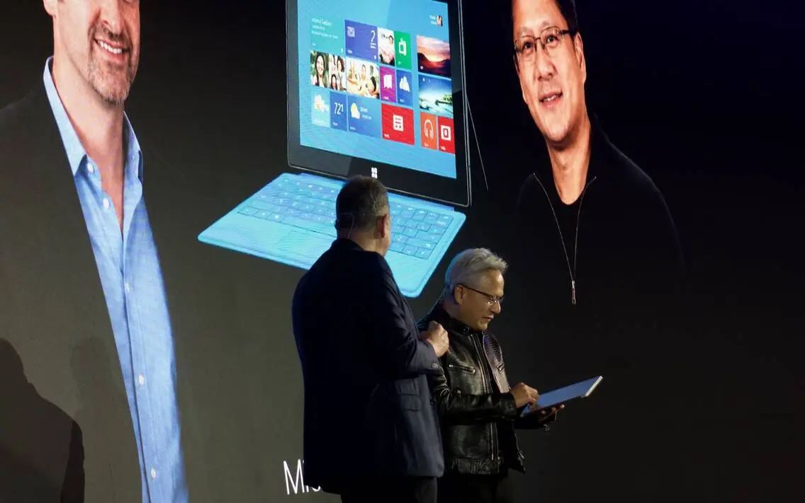 Arm CEO Rene Haas presenting Surface RT to Nvidia CEO Jensen Huang