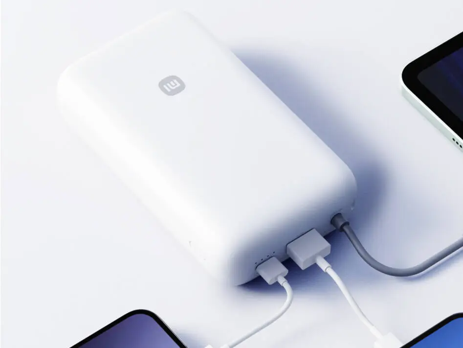 Xiaomi's 20,000mAh Power Bank Just Boosted Battery Health With a Built-In Cable Xiaomi 20,000mAh Power Bank with integrated cable on a white background
